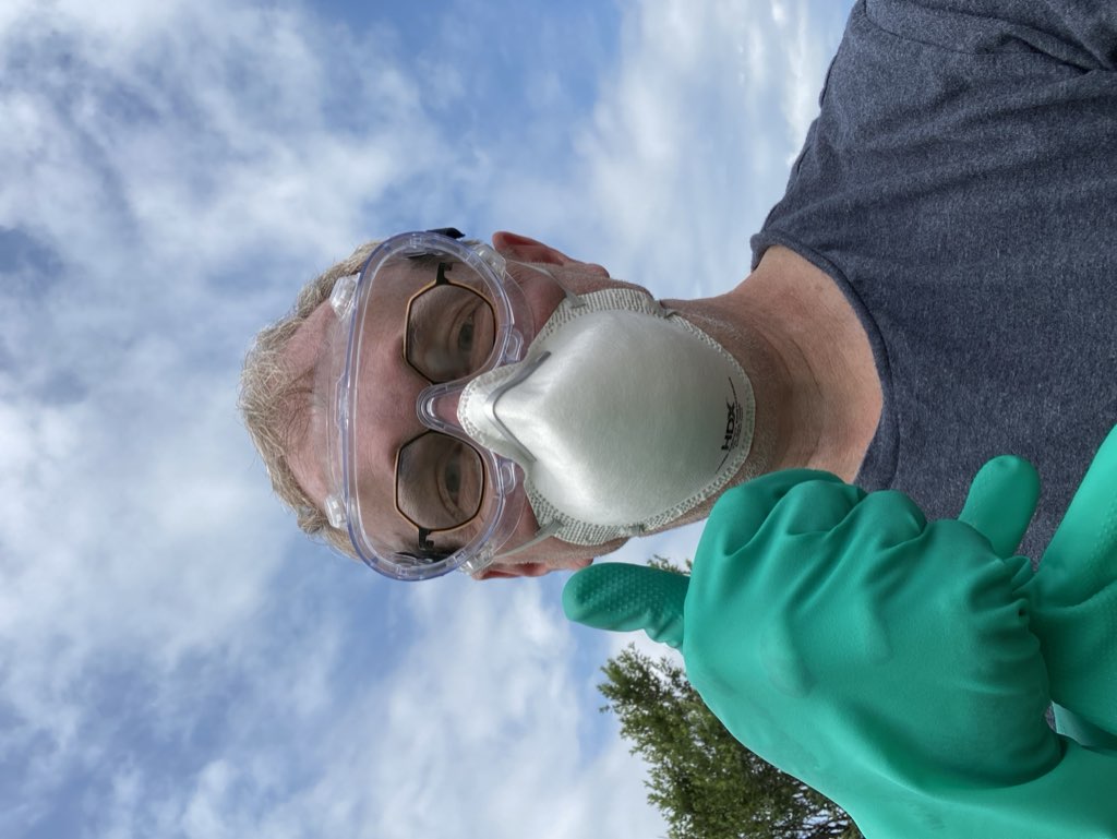 Selfie of my face, with eye goggles, N95 mask, and green nitrile gloves on my hands.