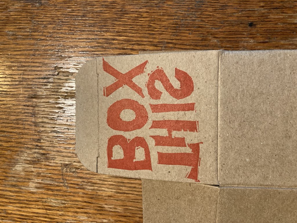 The words THIS BOX, backwards, printed on a cardboard box.