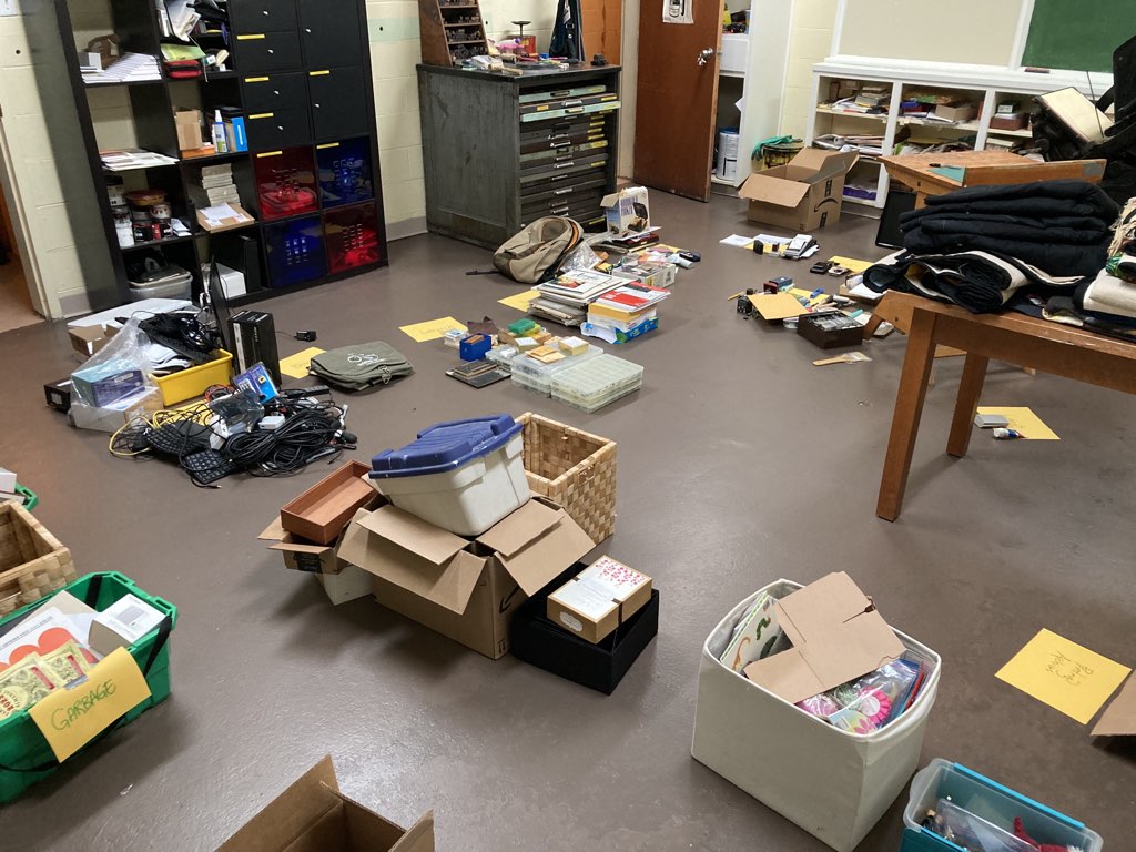 A photo of my basement office, with piles of like things gathered together spread over the floor.