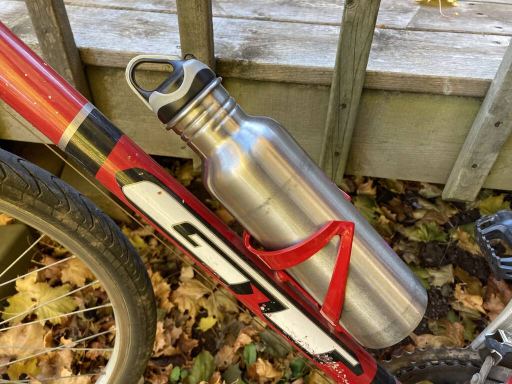 Photo of my new red water bottle rack on my bike.