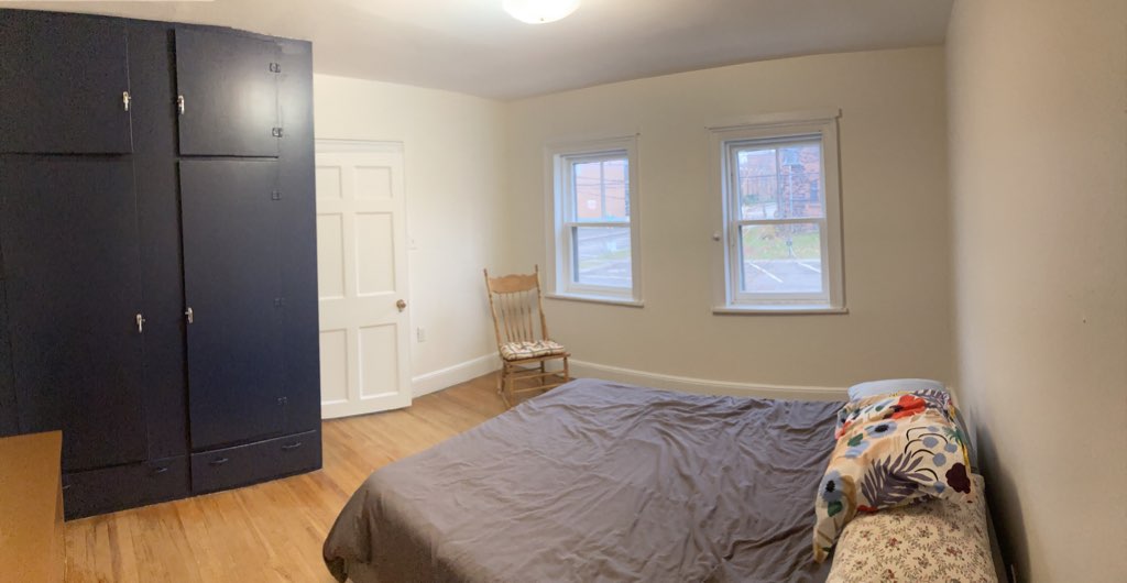 The same room, now painted white, with blue cupboards.
