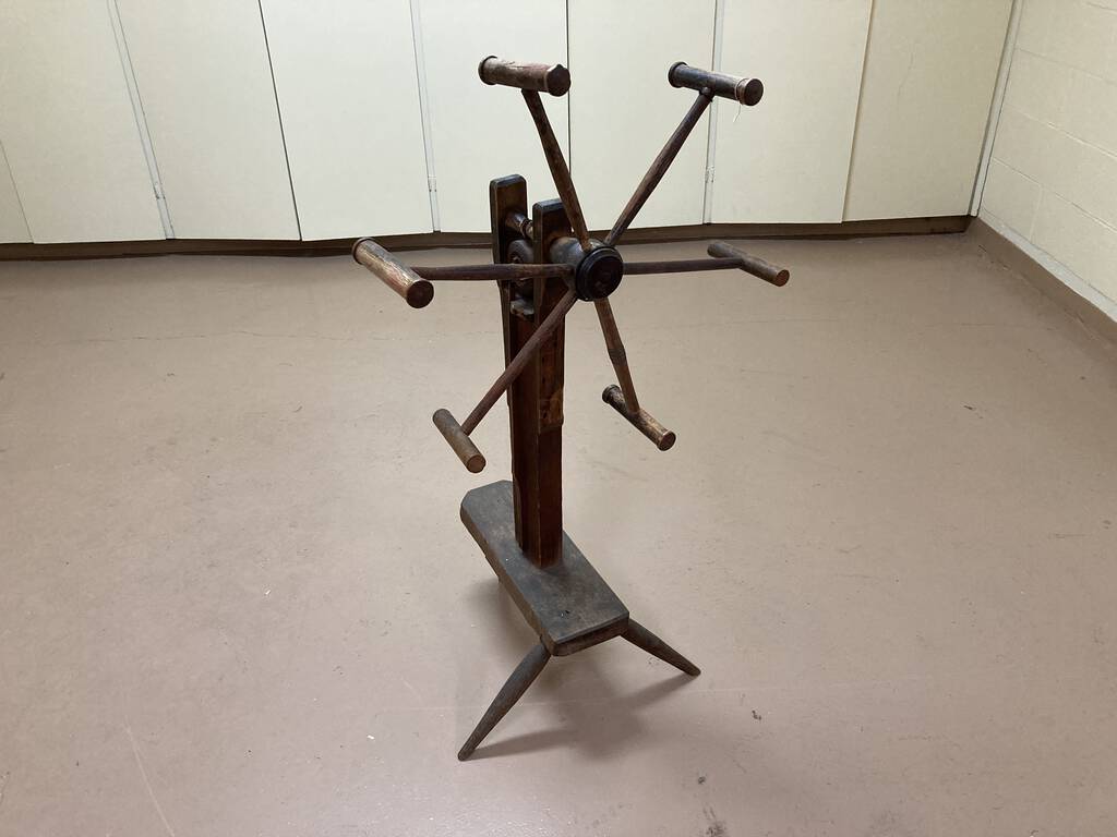 Photo of an antique wooden yarn winder.