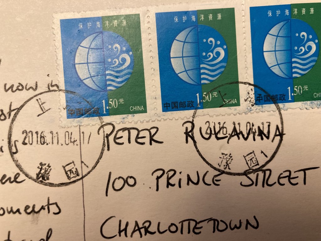 The stamps and postmarks on the reverse of the postcard.